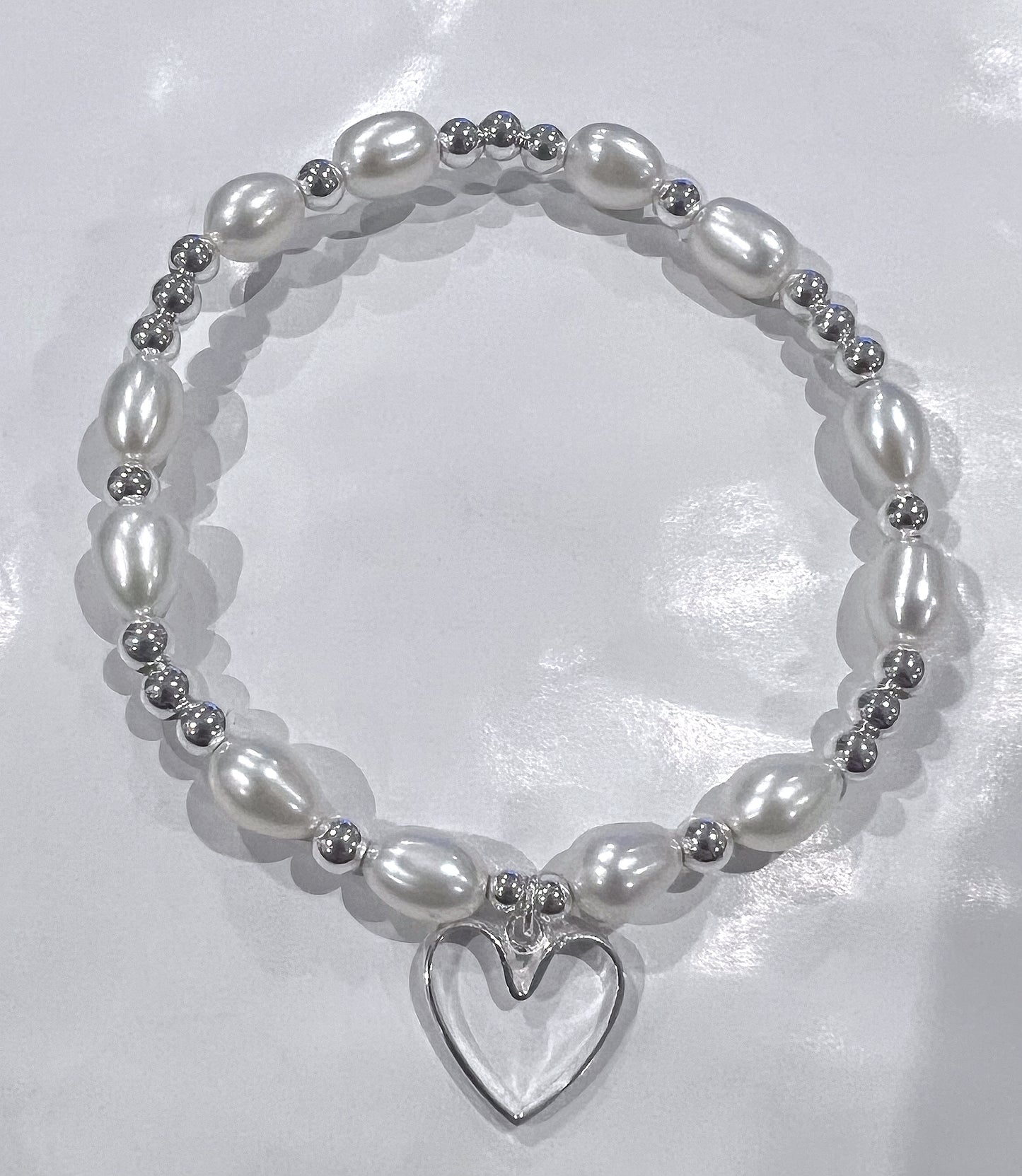 Freshwater pearl and silver open heart bracelet